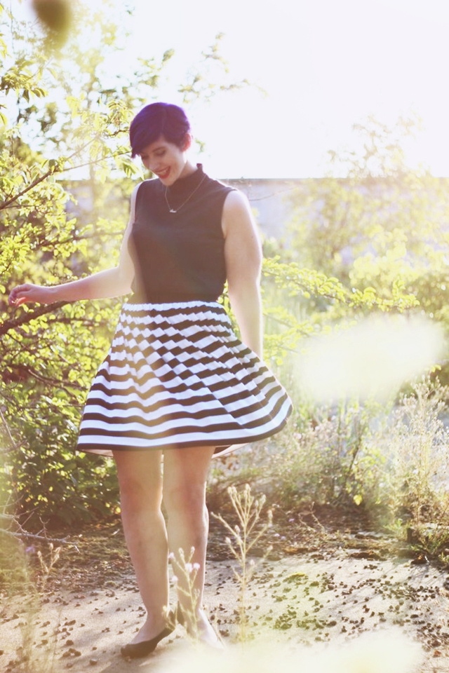 Outfit: Striped skirt, black sleeveless mock turtleneck, dainty gold necklace, black flats, purple pixie cut