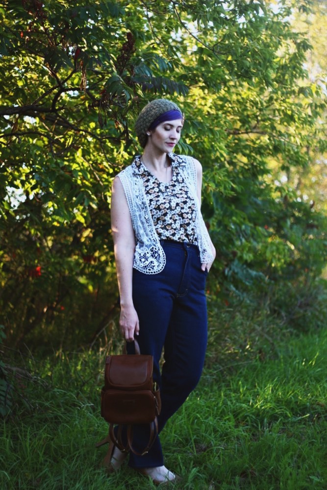 That '70s Outfit | The Outfit Repeater 1970s Inspired Outfit: Floral blouse, white lace vest, high waisted dark wash denim, high heels, mini brown backpack