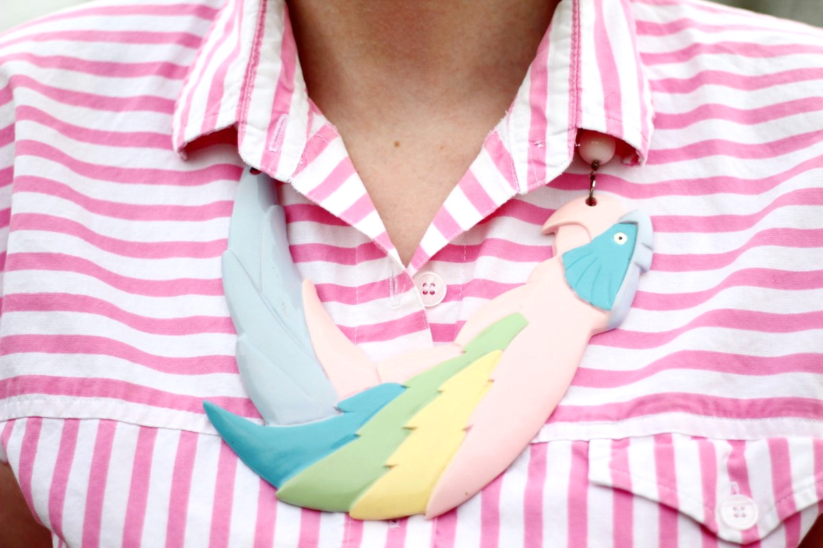 Outfit details: pink striped shirt and parrot shaped statement necklace