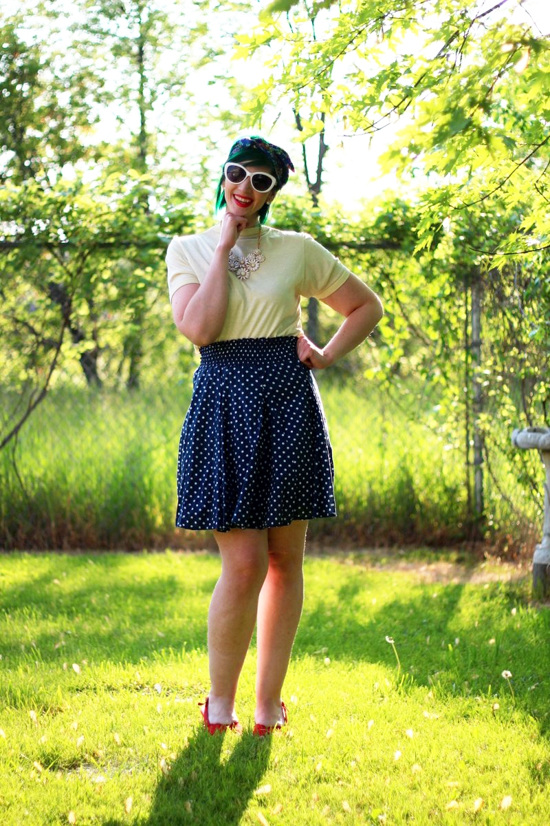 Outfit: primary colors, yellow t-shirt, navy blue polka dot skirt, floral headscarf, flower bib necklace, red lipstick, red kitten heels