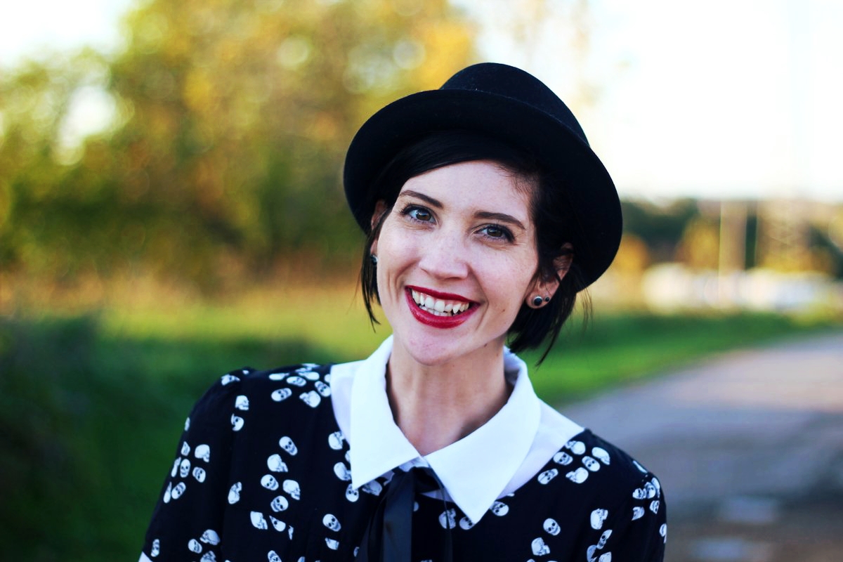 Portrait: Skull and crossbone dress, white button down, DIY ribbon, pork pie hat, dark lipstick