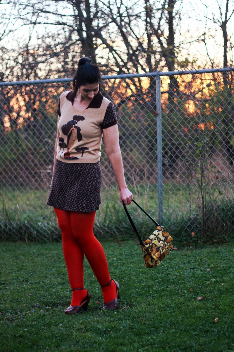 A Fun Way To Wear a Vintage Sweater Vest | www.theoutfitrepeater.com Outfit: Brown mini dress, vintage vest, orange lipstick, orange tights, ugly yellow purse, brown chunky heels