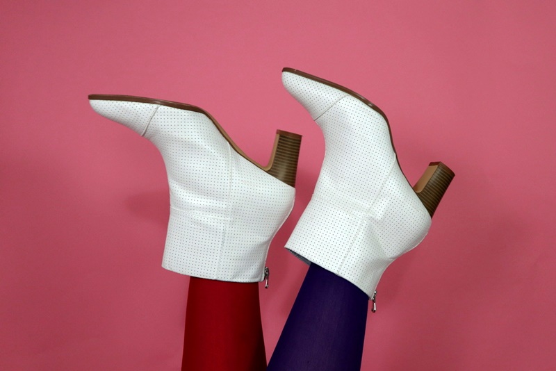 pink background, womens legs wearing red and purple tights with trendy white gogo boots, hannah rupp the outfit repeater